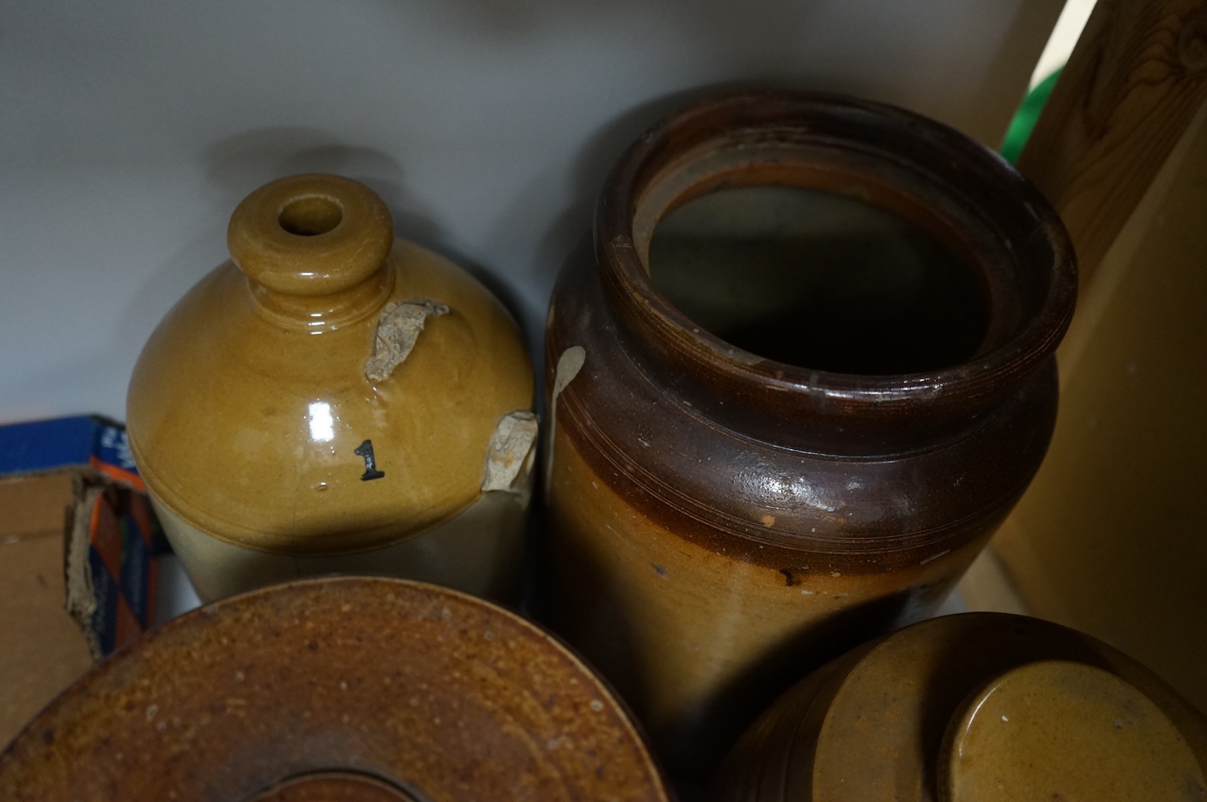 Four Victorian stoneware flagons / jars, five copper/brass saucepans and a funnel, largest 33cm high